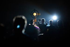 a group of people standing in the dark